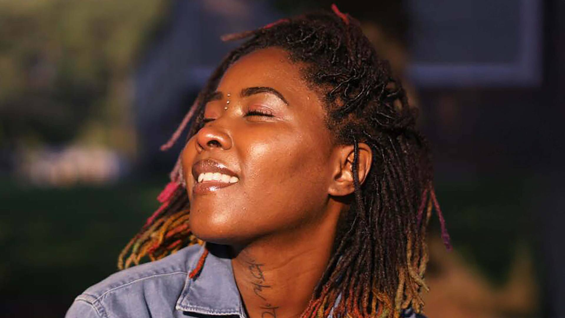 Portrait of a smiling woman with eyes closed enjoying sunlight – KM Digital Photography